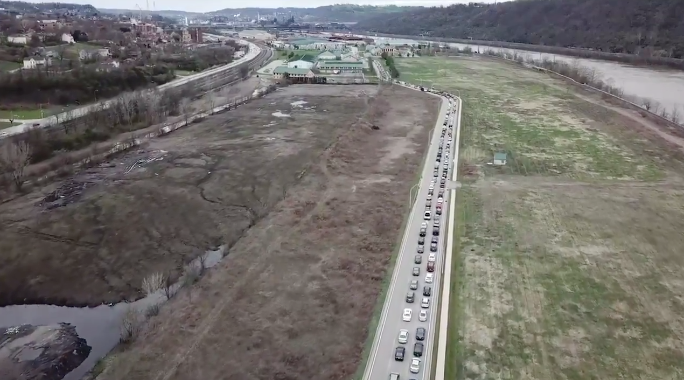 still from a video of miles of cars in Duquesne, Pennsylvania, waiting for food from a food bank