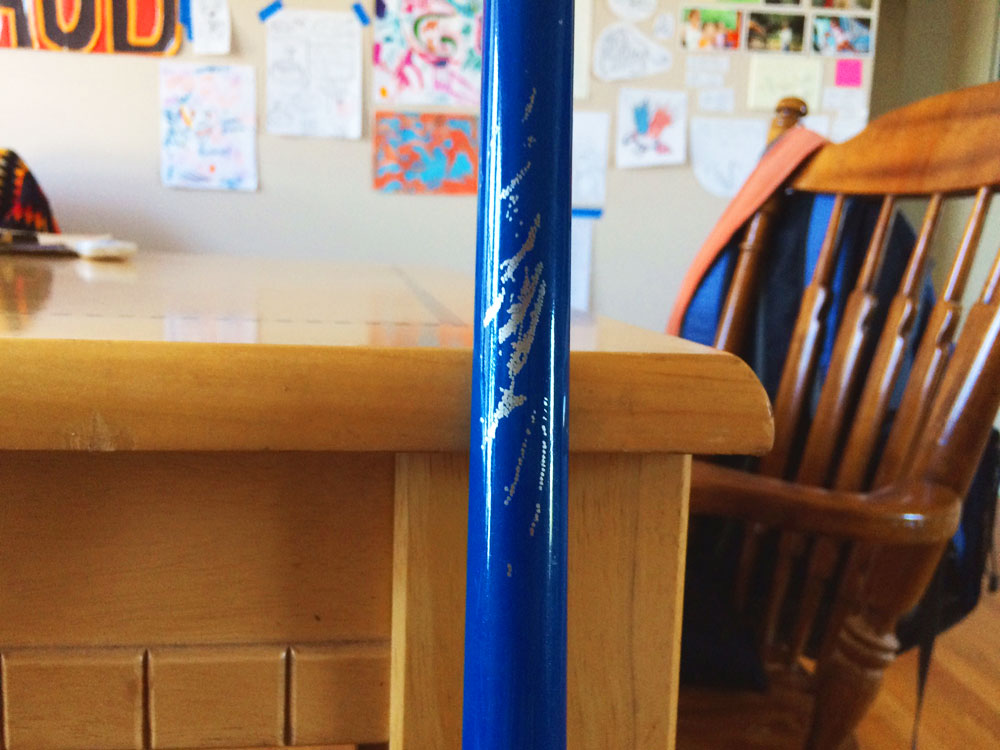 scratches in blue paint of broom handle
