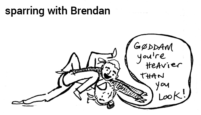 caption: sparring with Brendan | picture: erica has Brendan in side control, Brendan says, 'g0ddam you're heavier than you look!''